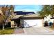 Charming one-story home featuring a two-car garage, solar panels, and a well-maintained front yard at 5856 Sutcliffe Cir, Las Vegas, NV 89110