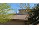 Upper story of the house with a brown shingle roof seen through trees at 5856 Sutcliffe Cir, Las Vegas, NV 89110