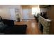 Open-concept living room with hardwood floors and stone fireplace at 5856 Sutcliffe Cir, Las Vegas, NV 89110