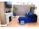 Living room featuring a stone fireplace, hardwood floors and a plush sofa at 5856 Sutcliffe Cir, Las Vegas, NV 89110