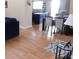 Open-concept living area with dining table, modern furniture, and beautiful flooring for relaxed living and entertaining at 5856 Sutcliffe Cir, Las Vegas, NV 89110
