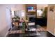 An airy living space with fireplace and TV, seamlessly integrates with a dining area to create an inviting atmosphere at 5856 Sutcliffe Cir, Las Vegas, NV 89110