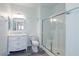 Bathroom featuring white cabinets, marble countertop, updated fixtures, glass enclosed shower and gray wood flooring at 6160 Rumrill St # 201, Las Vegas, NV 89113