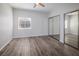 Bright bedroom featuring gray wood flooring, mirrored closet doors and large window for natural light at 6160 Rumrill St # 201, Las Vegas, NV 89113