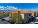 Apartment building showcasing the red tile roof, exterior paint colors, covered parking, and surrounding mountain views at 6160 Rumrill St # 201, Las Vegas, NV 89113