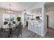 Bright dining area and kitchen featuring an open layout, stainless steel appliances, and modern countertops at 6160 Rumrill St # 201, Las Vegas, NV 89113