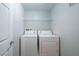 Laundry room with stacked washer and dryer, wire shelving and neutral walls at 6160 Rumrill St # 201, Las Vegas, NV 89113