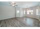 Open-concept living space featuring a ceiling fan, hardwood floors, and access to an outdoor area at 6160 Rumrill St # 201, Las Vegas, NV 89113