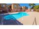 Community pool with lounge chairs and view of the buildings at 6160 Rumrill St # 201, Las Vegas, NV 89113