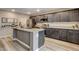 Well-equipped kitchen featuring stainless steel appliances, dark cabinetry, and a large center island at 6859 Crimson Shadow St, North Las Vegas, NV 89086