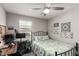 Bright bedroom featuring natural light, a ceiling fan, and a cozy quilt on a metal frame bed at 703 Sleeping City Ave, Henderson, NV 89015