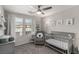 Welcoming Bedroom featuring a crib, glider, and charming decor creating a serene atmosphere at 703 Sleeping City Ave, Henderson, NV 89015