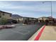 Gated community entrance with mountain views and well-maintained asphalt at 703 Sleeping City Ave, Henderson, NV 89015