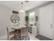 Cozy dining area with a round table, four chairs, and stylish decor at 703 Sleeping City Ave, Henderson, NV 89015