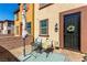 Cozy front porch featuring comfortable seating, a decorative wreath, and a welcoming entrance at 703 Sleeping City Ave, Henderson, NV 89015