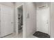 Hallway view leading to a powder room with wall decor and tile flooring at 703 Sleeping City Ave, Henderson, NV 89015