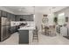 Stylish kitchen featuring stainless steel appliances, gray cabinets, and an adjacent dining area at 703 Sleeping City Ave, Henderson, NV 89015