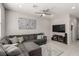 Relaxing living room with a large sectional sofa, stylish rug, and mounted TV at 703 Sleeping City Ave, Henderson, NV 89015