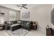Comfortable living room with a sectional sofa, decorative accents, and tile flooring at 703 Sleeping City Ave, Henderson, NV 89015