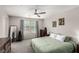 Spacious main bedroom with carpet flooring, a ceiling fan, and two windows at 703 Sleeping City Ave, Henderson, NV 89015