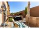 Outdoor patio area with comfortable seating, a grill, and privacy fence at 703 Sleeping City Ave, Henderson, NV 89015