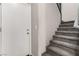 Carpeted staircase with gray walls leads to the upper level of the home at 703 Sleeping City Ave, Henderson, NV 89015