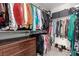 Walk-in closet with hanging racks for clothes and storage for shoes at 703 Sleeping City Ave, Henderson, NV 89015