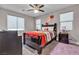 Comfortable bedroom featuring a ceiling fan, neutral paint and a large window offering plenty of natural light at 7333 Night Sky St, North Las Vegas, NV 89084