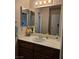 Bathroom featuring a dark wood vanity, sink, and mirror at 741 Bourbon St # E3, Pahrump, NV 89048