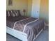 Bedroom with a queen size bed, neutral color scheme, and a door on the wall at 741 Bourbon St # E3, Pahrump, NV 89048
