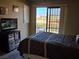 Bedroom with a queen size bed, tv, storage unit, and sliding glass door with view to the outdoor area at 741 Bourbon St # E3, Pahrump, NV 89048