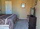 Bedroom with a queen size bed, tv, and a door on the wall at 741 Bourbon St # E3, Pahrump, NV 89048