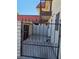 Private courtyard featuring wrought-iron gate, brick wall, and access to the home's exterior at 741 Bourbon St # E3, Pahrump, NV 89048