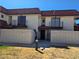 Stylish condo exterior with red tile roof, dual balconies, and brick privacy fence at 741 Bourbon St # E3, Pahrump, NV 89048