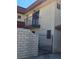 Exterior view featuring gated courtyard, stucco facade, and balcony, offering privacy and charm at 741 Bourbon St # E3, Pahrump, NV 89048