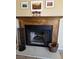 Traditional wood fireplace with decorative mantel and hearth featuring desert artwork and rustic decor at 741 Bourbon St # E3, Pahrump, NV 89048