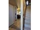 Hallway with tile flooring, closet space, and a view into the living area with stairs at 741 Bourbon St # E3, Pahrump, NV 89048