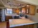 Spacious kitchen area featuring stainless steel appliances, wood cabinets, and tile countertops at 741 Bourbon St # E3, Pahrump, NV 89048