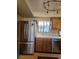 Kitchen area featuring a stainless steel refrigerator, sink, and modern appliances at 741 Bourbon St # E3, Pahrump, NV 89048