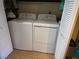 Laundry room with white washer and dryer units, and louvered doors at 741 Bourbon St # E3, Pahrump, NV 89048