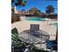 Relaxing pool area with patio table, chairs, and inviting swimming pool, perfect for outdoor entertaining at 741 Bourbon St # E3, Pahrump, NV 89048