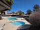 Community pool and hot tub surrounded by lounge chairs and mature trees, perfect for relaxation at 741 Bourbon St # E3, Pahrump, NV 89048