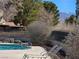 Tranquil pool area featuring lounge chairs, mature landscaping, and serene atmosphere at 741 Bourbon St # E3, Pahrump, NV 89048
