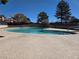 Inviting swimming pool with shallow end, surrounded by concrete patio and well-maintained landscaping at 741 Bourbon St # E3, Pahrump, NV 89048