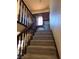 Carpeted staircase with wooden railing leads to an office nook with a window at 741 Bourbon St # E3, Pahrump, NV 89048