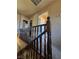 Upstairs hallway with wood railing leads to various rooms with carpet flooring at 741 Bourbon St # E3, Pahrump, NV 89048