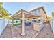 Backyard oasis featuring a covered patio, built-in grill, lush green lawn, and a sparkling pool at 7520 Jacaranda Bay St, Las Vegas, NV 89139