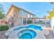 Backyard with mature landscaping, swimming pool, spa, and lush green grass at 7520 Jacaranda Bay St, Las Vegas, NV 89139