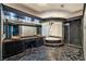 Luxurious bathroom with dark stone floor, granite countertops, unique lighting and glass enclosed shower at 7520 Jacaranda Bay St, Las Vegas, NV 89139