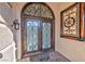 Elaborate wrought iron double front door is set in an arched entry at 7520 Jacaranda Bay St, Las Vegas, NV 89139